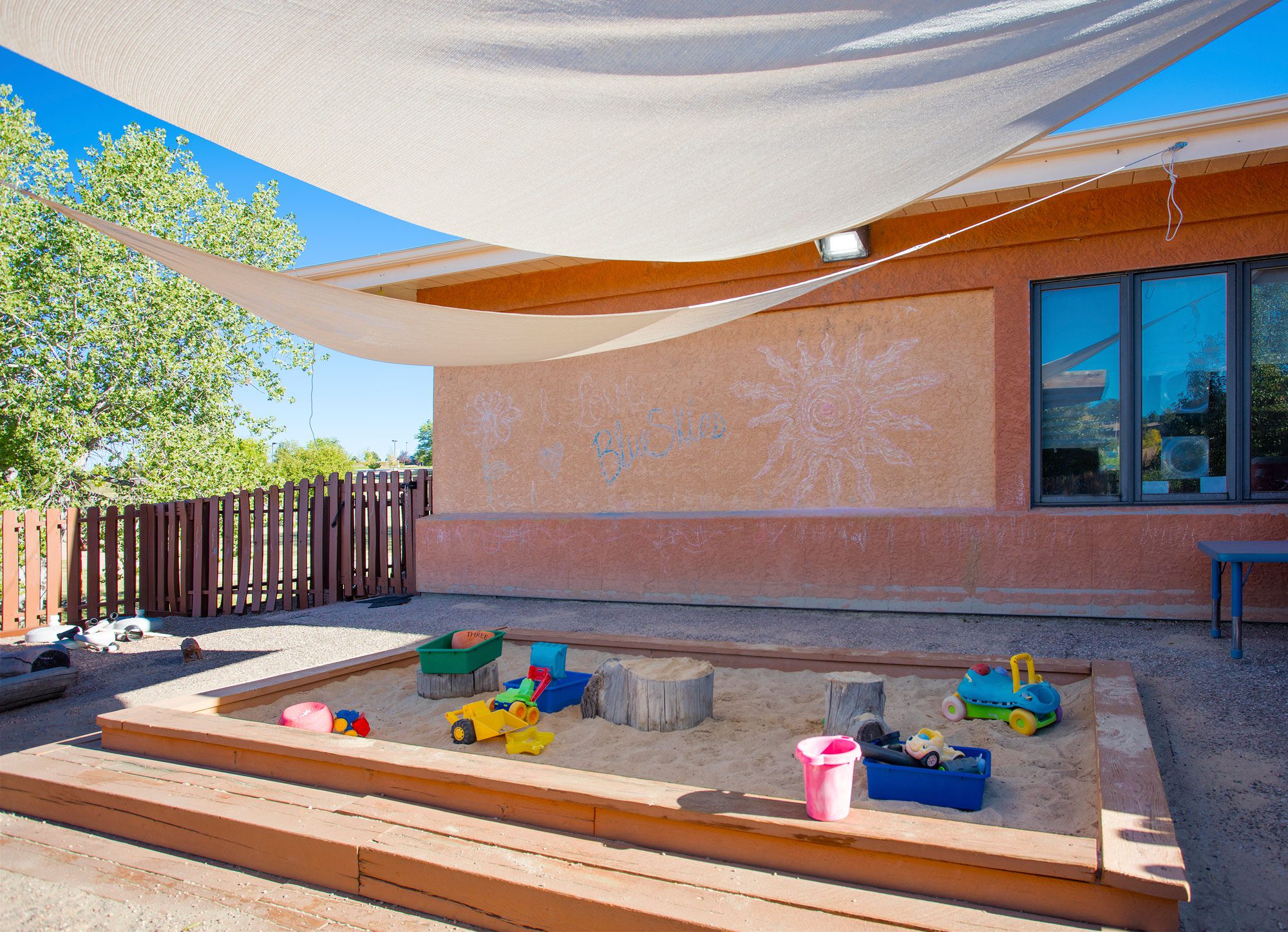 Image of sandbox with toys outside of the learning center.